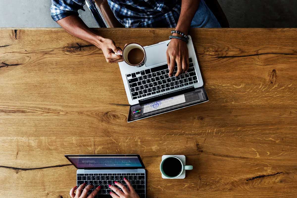 Overhead shot of laptops and coffee